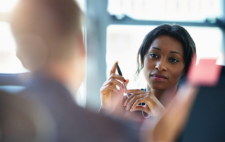 Woman holding pen in interview